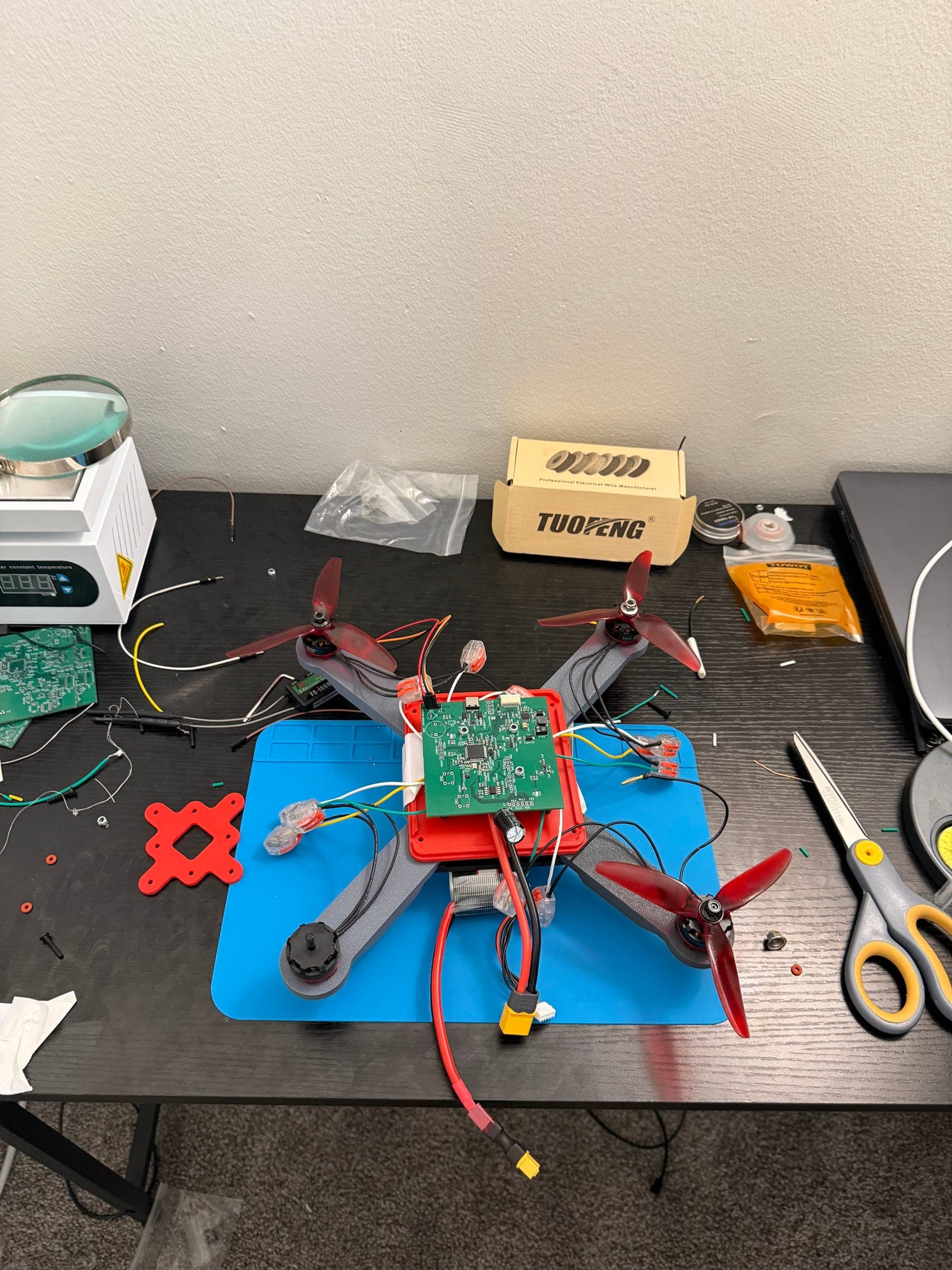 Flight controller board mounted to the quadcopter frame on the bench, motors and receiver wired in